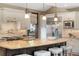 Gourmet kitchen with stainless steel appliances, granite countertops, and center island with bar stool seating at 1376 S Clayton St, Denver, CO 80210