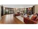 Bright living room with hardwood floors, fireplace, and access to an outdoor patio at 1376 S Clayton St, Denver, CO 80210
