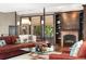 Spacious living room featuring a brick fireplace, large windows, and a comfortable leather sectional sofa at 1376 S Clayton St, Denver, CO 80210