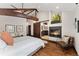 Tranquil main bedroom with a fireplace, hardwood floors, and a sliding barn door at 1376 S Clayton St, Denver, CO 80210