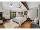 Cozy main bedroom featuring a fireplace, skylight, and access to a balcony at 1376 S Clayton St, Denver, CO 80210