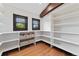Walk-in pantry featuring custom shelves, wooden floors, and natural light at 1376 S Clayton St, Denver, CO 80210