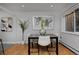 Bright dining area with hardwood floors and a four-person table at 1149 Columbine St # 104, Denver, CO 80206