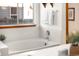 Soaking tub with window and tile surround at 9053 W 103Rd Ave, Broomfield, CO 80021