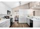 Modern kitchen with white cabinets and black appliances at 9053 W 103Rd Ave, Broomfield, CO 80021