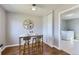 Dining area featuring stylish seating, hardwood floors, and a view into the laundry room at 1120 Quince St, Denver, CO 80220