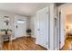 Bright entryway featuring hardwood floors, a white door with glass panes, and neutral wall paint at 1120 Quince St, Denver, CO 80220