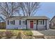 Charming single-story home featuring a red front door, neutral siding, and a well-maintained front yard at 1120 Quince St, Denver, CO 80220