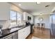 Bright kitchen features stainless steel appliances, white cabinets, and granite countertops at 1120 Quince St, Denver, CO 80220