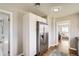 Bright kitchen featuring stainless steel refrigerator and a view into the adjacent living room at 1120 Quince St, Denver, CO 80220