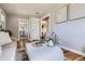 Open-concept living room showcasing hardwood floors, neutral paint, and a view into other rooms at 1120 Quince St, Denver, CO 80220