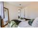 Comfortable main bedroom featuring a large mirror, decor accents, and neutral colors at 1120 Quince St, Denver, CO 80220