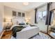 Cozy main bedroom featuring natural light, warm hardwood floors, and stylish decor at 1120 Quince St, Denver, CO 80220