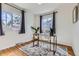 Bright office space with hardwood floors, large windows, and designer rug at 1120 Quince St, Denver, CO 80220