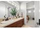 Bathroom featuring a double sink vanity and access to a room at 9586 Silent Hills Ln, Lone Tree, CO 80124