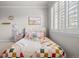 Bedroom with a large window and patterned bedding at 9586 Silent Hills Ln, Lone Tree, CO 80124