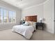 Bedroom with a large window, plantation shutters and two side tables at 9586 Silent Hills Ln, Lone Tree, CO 80124