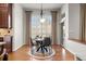 Cozy dining area with a round table, neutral colors, and large windows at 9586 Silent Hills Ln, Lone Tree, CO 80124