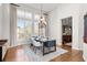 Bright dining room with hardwood floors, chandelier, and large windows offering natural light at 9586 Silent Hills Ln, Lone Tree, CO 80124