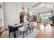 Dining area with a modern table, chandelier, and seamless connection to the living space at 9586 Silent Hills Ln, Lone Tree, CO 80124