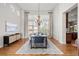 Formal dining area with hardwood floors, chandelier, and lots of natural light at 9586 Silent Hills Ln, Lone Tree, CO 80124