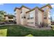 Beautiful home featuring a stone facade, green lawn, and a private outdoor living space at 9586 Silent Hills Ln, Lone Tree, CO 80124