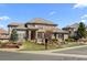 Beautiful two-story home with stone and stucco exterior, tile roof, and professionally landscaped front yard at 9586 Silent Hills Ln, Lone Tree, CO 80124