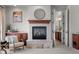 Elegant fireplace with stone surround, wood mantle, stylish decor, and built-in cabinets at 9586 Silent Hills Ln, Lone Tree, CO 80124