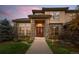 Stunning home exterior with brick accents, manicured lawn, and stately front door at 9586 Silent Hills Ln, Lone Tree, CO 80124