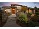 Elegant home exterior featuring a brick facade, landscaped garden, and covered entryway at 9586 Silent Hills Ln, Lone Tree, CO 80124
