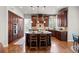 Spacious kitchen with wood cabinets, an island with seating, and stainless steel appliances at 9586 Silent Hills Ln, Lone Tree, CO 80124