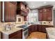 Stylish kitchen featuring granite countertops, stainless steel appliances, and wooden cabinets at 9586 Silent Hills Ln, Lone Tree, CO 80124