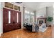 Bright living room with hardwood floors, a fireplace, and large windows with plantation shutters at 9586 Silent Hills Ln, Lone Tree, CO 80124