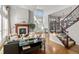 Open-concept living space with fireplace, staircase, and plenty of natural light at 9586 Silent Hills Ln, Lone Tree, CO 80124
