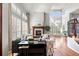 Spacious living room with a fireplace, high ceilings, hardwood floors, and ample natural light at 9586 Silent Hills Ln, Lone Tree, CO 80124