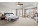 Spacious main bedroom with tray ceilings, large windows, sitting area, and neutral carpeting at 9586 Silent Hills Ln, Lone Tree, CO 80124
