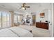 Beautiful main bedroom featuring a fireplace, sitting area, large windows, and stylish built-in cabinets at 9586 Silent Hills Ln, Lone Tree, CO 80124