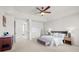 Spacious main bedroom suite featuring a large bed, bench, sleek built-ins, and ample natural light at 9586 Silent Hills Ln, Lone Tree, CO 80124
