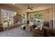 Inviting covered patio features a brick fireplace, comfortable seating, and a built-in grill at 9586 Silent Hills Ln, Lone Tree, CO 80124