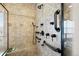 Tiled shower featuring grab bars and multiple shower heads at 9586 Silent Hills Ln, Lone Tree, CO 80124