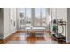 Sunlit sitting area features hardwood floors, plantation shutters, and stylish decor at 9586 Silent Hills Ln, Lone Tree, CO 80124