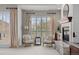 Cozy sitting room featuring large shuttered windows with drapes, a stone fireplace and modern decor at 9586 Silent Hills Ln, Lone Tree, CO 80124