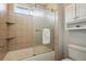Bathroom featuring a bathtub with shower, updated tile and bright natural light at 3571 S Kittredge St # C, Aurora, CO 80013