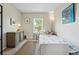 Cozy bedroom features a twin bed, side table and chest with light neutral color and natural light from window at 3571 S Kittredge St # C, Aurora, CO 80013