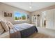 Bedroom featuring neutral tones, plush carpet and a bright window with a leafy view at 3571 S Kittredge St # C, Aurora, CO 80013