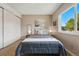 Cozy bedroom with neutral tones, a ceiling fan, comfortable carpet and a bright window view at 3571 S Kittredge St # C, Aurora, CO 80013