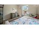 A cute bedroom featuring a comfortable twin bed with a bedside table and dresser at 3571 S Kittredge St # C, Aurora, CO 80013