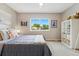 Bedroom featuring neutral tones, plush carpet and a bright window with a leafy view at 3571 S Kittredge St # C, Aurora, CO 80013