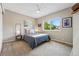 Cozy bedroom with neutral tones, a ceiling fan, comfortable carpet and a bright window view at 3571 S Kittredge St # C, Aurora, CO 80013
