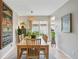 Bright dining room with a large wooden table and sliding glass doors leading outside at 3571 S Kittredge St # C, Aurora, CO 80013